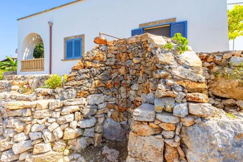 a stone wall in front of a house at Casa delle sorgenti in Torre Vado