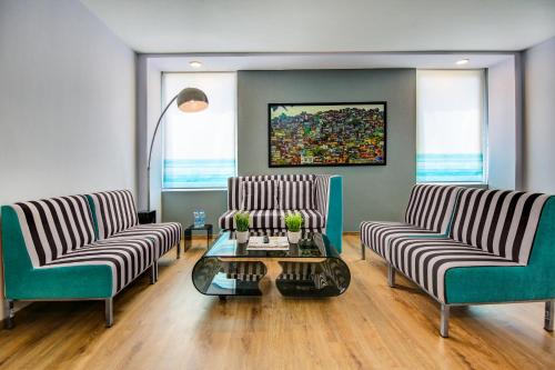 a living room with two chairs and a table at Sunday Hotel Chandigarh Zirakpur in Zirakpur