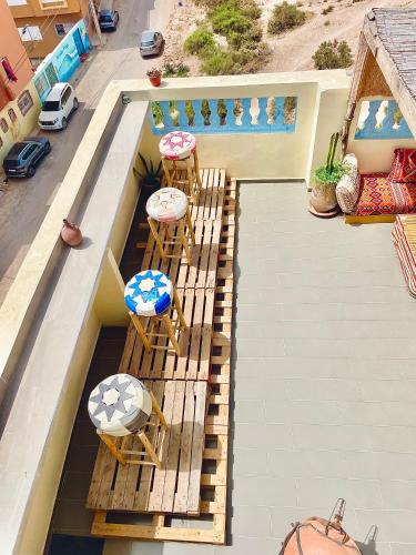 an overhead view of a balcony with chairs and a swimming pool at Waveside surf house in Tamraght Oufella