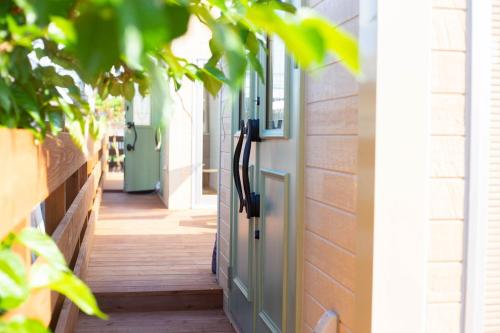 a hallway of a house with a door at OKINAWA GREEN LODGE in Okinawa City