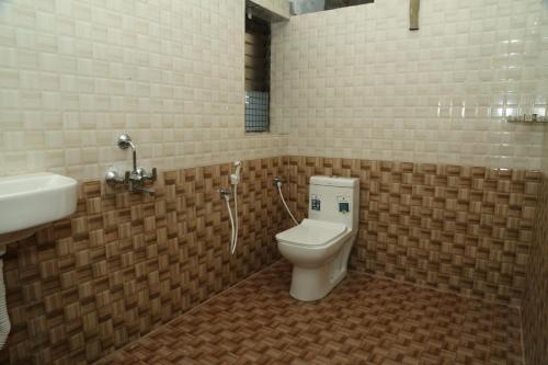 a bathroom with a toilet and a sink at MM Residency Mogappair in Chennai