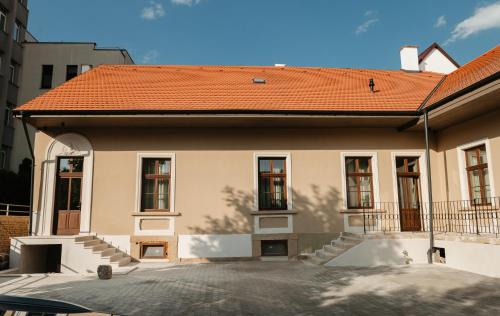 a house with an orange roof with a driveway at Villa Botar in Cluj-Napoca