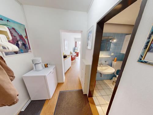 a small bathroom with a sink and a mirror at Seehütte - 304 in Cuxhaven
