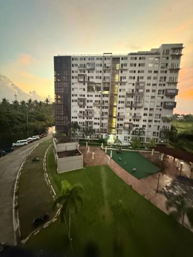 a large building with a green yard in front of it at Your Perfect Staycation at Monteluce in Silang