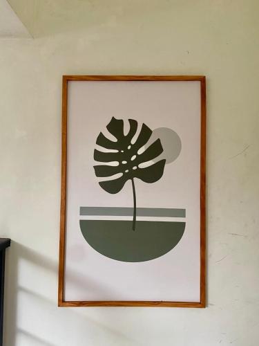 a framed picture of a flower on a wall at Z Malang Hostel in Malang
