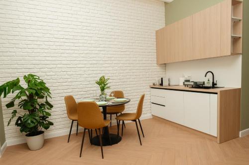 a kitchen with a table and chairs in a room at Villa Botar in Cluj-Napoca