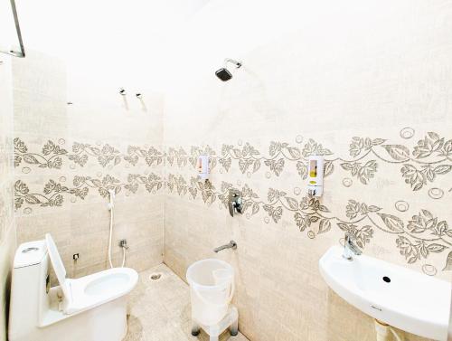 a bathroom with a toilet and a sink at Hotel Himaaksh cottages In Sigri in Nainital