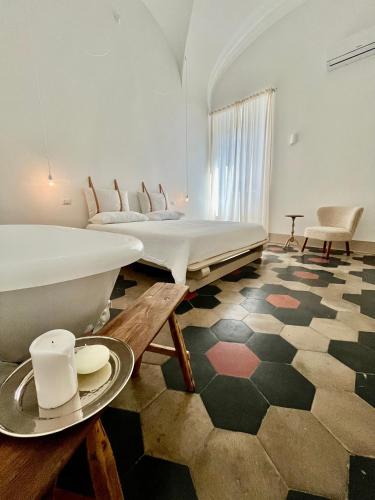 a room with two beds and a table with a plate on it at La Cocca Via Saffi, con vasca in camera in Viterbo