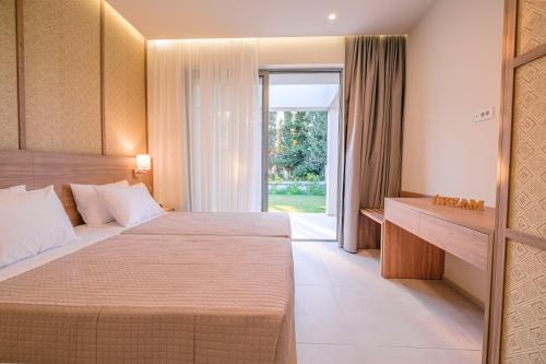 a hotel room with two beds and a window at THEODOROU villas in Kos Town