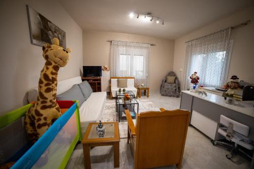 a living room with a stuffed giraffe in the middle of the room at Eleni's GuestHouse in Ágios Vissaríon