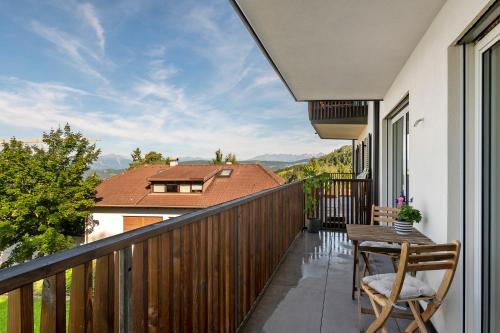 a balcony with a table and chairs and a view at Apartment Anna in Soprabolzano