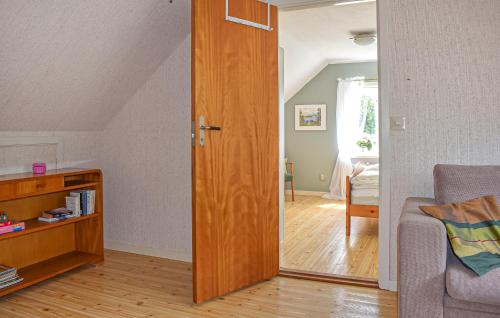 a living room with a door leading into a room at Nice Home In Gärds Köpinge in Gärds Köpinge