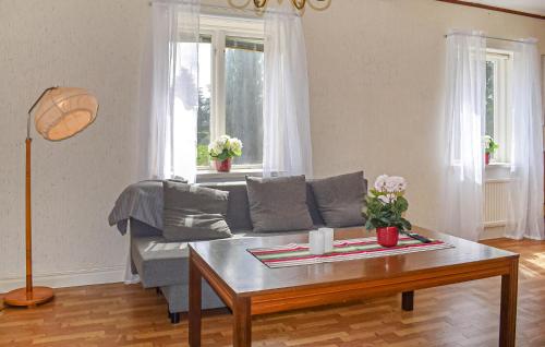 a living room with a couch and a coffee table at Nice Home In Gärds Köpinge in Gärds Köpinge