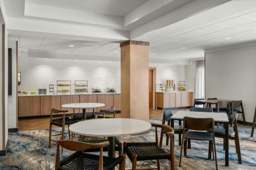 a lobby with tables and chairs and a counter at Fairfield Inn and Suites New Buffalo in New Buffalo