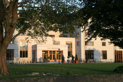 a white building with a tree in front of it at The Brehon Hotel & Spa in Killarney