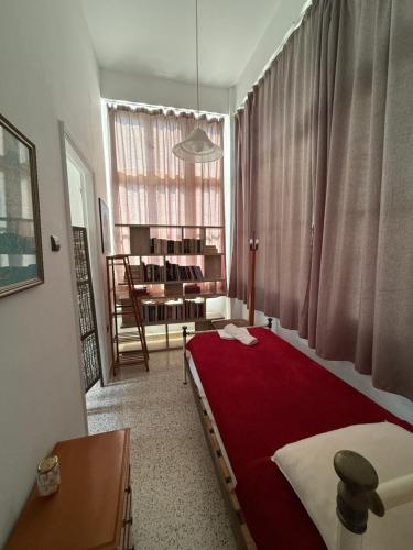 a bedroom with a bed with a red blanket at Tower Traditional Pool Villa in Kremasti