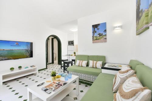 a living room with a couch and a table at Campo Golf 68 by VillaGranCanaria in Las Palmas de Gran Canaria