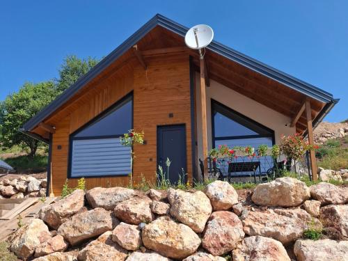 a house with a stone wall in front of it at Sunnyside apartments in Kruščanje