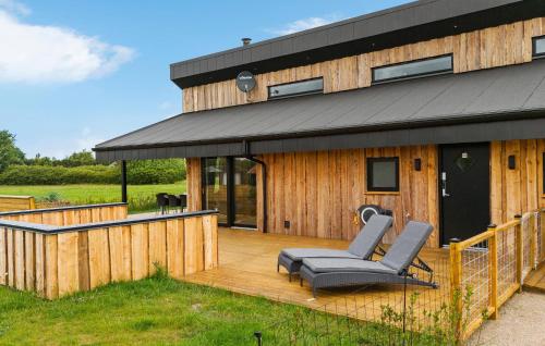 a large wooden deck with a black roof at 3 Bedroom Awesome Home In Tarm - P52739 in Tarm