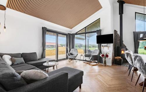 a living room with a couch and a fireplace at 3 Bedroom Awesome Home In Tarm - P52739 in Tarm