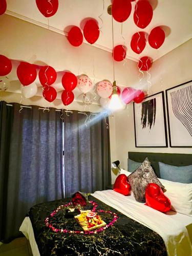 a room with two beds with red and white balloons at The Lagoon in Pretoria