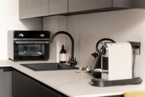 a kitchen counter with a sink and a microwave at Moment Blythswood St in Glasgow