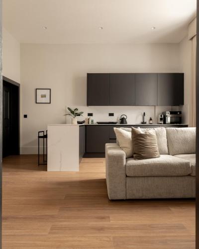 a living room with a couch and a kitchen at Moment Blythswood St in Glasgow