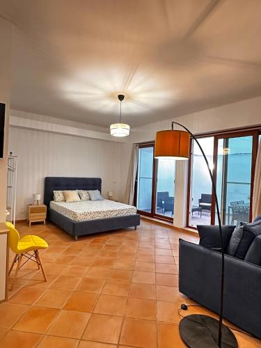 a living room with a bed and a couch at Kasa Mondello in Mondello