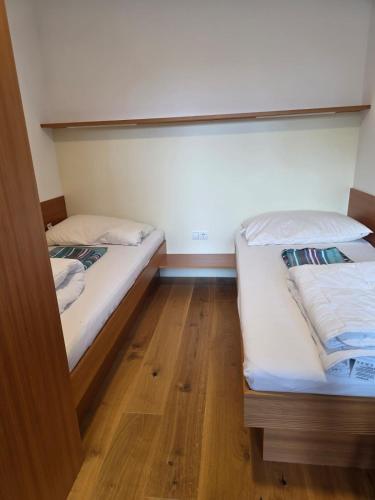 two bunk beds in a room with wooden floors at Appartement Cocoon 24 in Ischgl