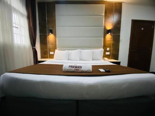 a bed in a hotel room with a towel on it at PRESKEN WHITE HOUSE in Lagos