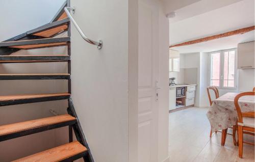 a room with a staircase and a kitchen with a table at Studio Coeur De Ville in Solliès-Pont