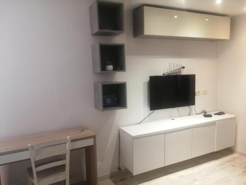 a living room with a tv on a wall at Pipilota in Rijeka