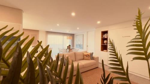 a living room with a couch and a plant at Apuliaapartments in Apúlia
