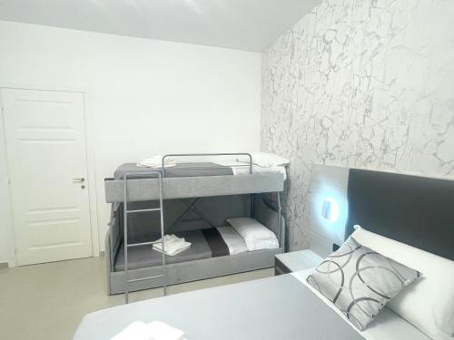 a small room with a bunk bed and a bed gmaxwell gmaxwell gmaxwell gmaxwell gmaxwell gmaxwell at B&B CORSO ROMA Room Suite & Spa in Apricena