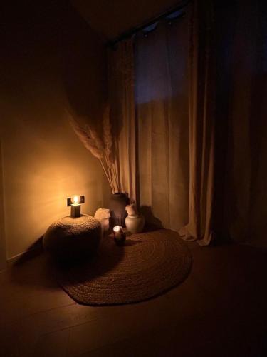 a dark room with a table with two candles on it at Noma in Gavere