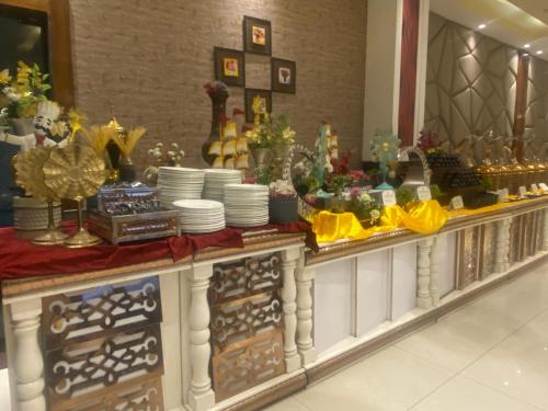 a buffet line with plates and dishes on it at Hotel Wedcaton By Tivoli - Ambala in Ambāla