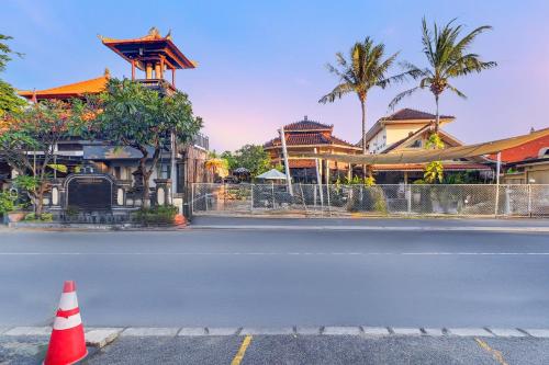 an empty street with a orange cone on the side of the road at Palette Signature Hotel in Sanur