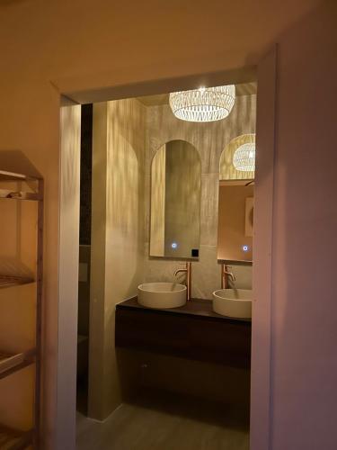 a bathroom with two sinks and a large mirror at Noma in Gavere