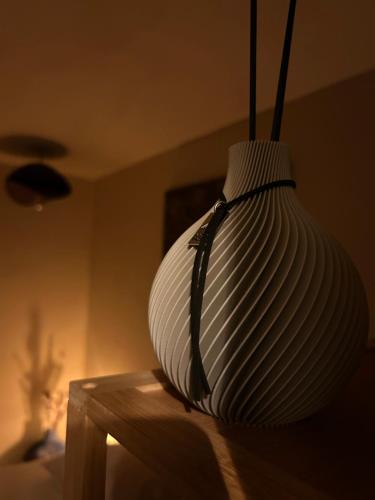 a white vase sitting on top of a table at Noma in Gavere