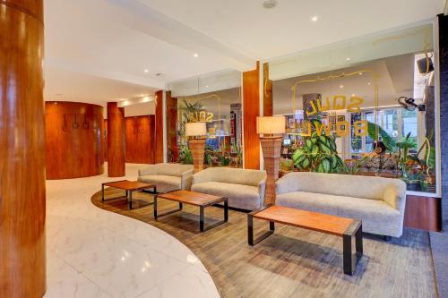 a lobby with couches and tables in a store at Palette Signature Hotel in Sanur
