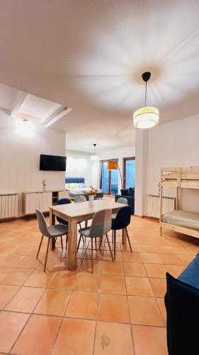 a dining room with a table and chairs and a couch at Kasa Mondello in Mondello