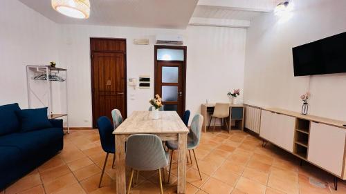 a living room with a table and a blue couch at Kasa Mondello in Mondello