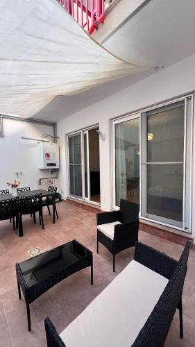 a living room with black furniture and a large window at Kasa Mondello in Mondello