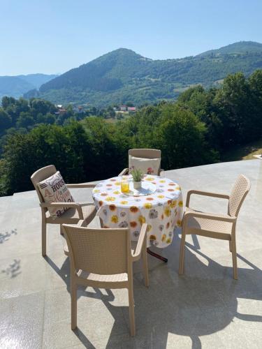 a table with two chairs and a table with a table cloth at Villa Queen in Visoko