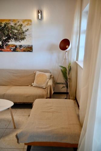 a living room with a couch and a table at Rastoni Apartments Skiathos in Troulos