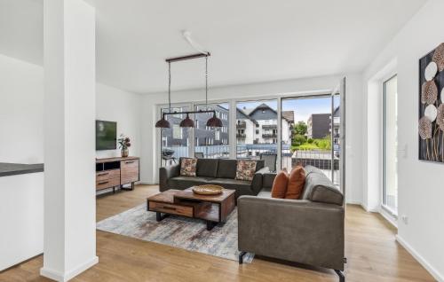 a living room with a couch and a table at Gebirgsresort Winterberg in Winterberg