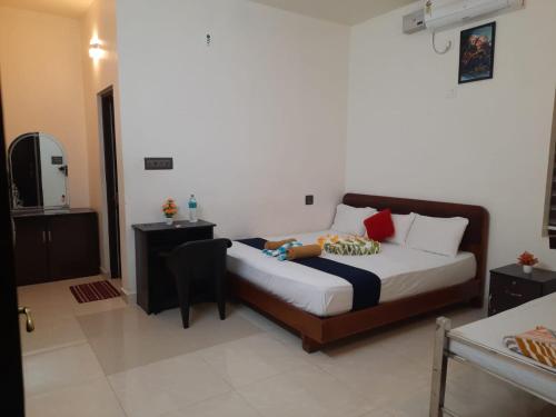 a bedroom with a bed with a person laying on it at Athirappilly Ambady Resort in Athirappilly