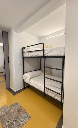 a bunk room with two bunk beds in it at Lambrusco - Harbor's Light in Villajoyosa