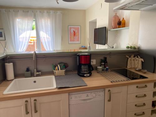 a kitchen with a coffee maker on a counter at La Papaline de Caroline in Saint-Saturnin-lès-Avignon
