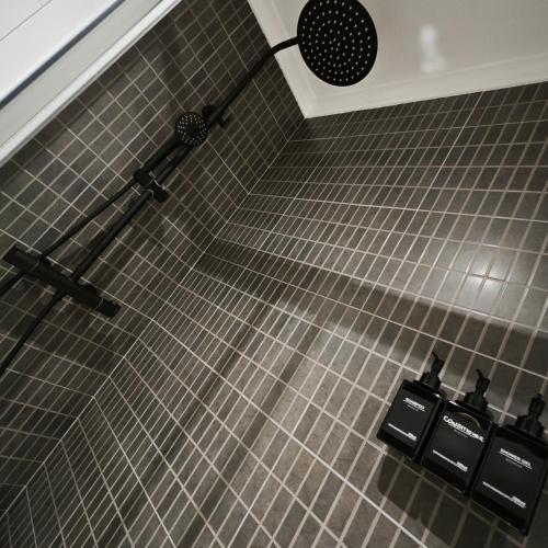 a tiled floor with a shower in a bathroom at Manisa I in Ribadeo